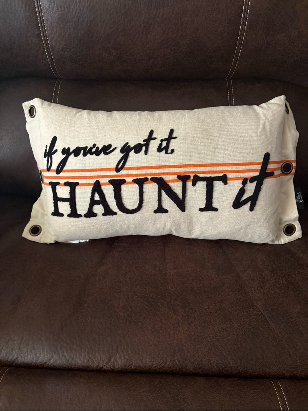 Halloween “If you got it haunt it” tan pillow with tarnished bronze detailing.